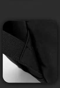 Detailed close-up of reinforced stitching and durable fabric texture on black backpack