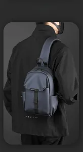 Rear view of a man wearing a water-resistant navy nylon crossbody bag with WEPOWER logo