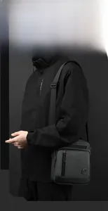 Dark grey waterproof shoulder bag for men shown on model for daily commuting