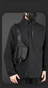 Close-up of black tactical chest bag with multiple zippers and adjustable nylon strap