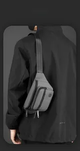 Detail view of water-resistant casual waist bag with multiple zippers and adjustable strap