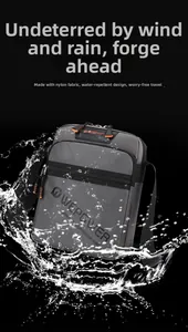 Close-up of dark grey waterproof nylon crossbody bag with splashes showing water resistance