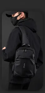 Close-up of waterproof black crossbody bag with We Power logo and buckle pocket detail