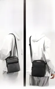Detail of multi-pocket nylon crossbody bag showing gray and black styles with adjustable straps