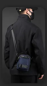 Close-up of waterproof men's crossbody bag with adjustable strap on a male model
