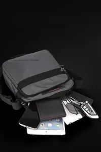 Detailed top view of a grey crossbody bag showing large capacity with organized inner layers