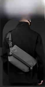 Borsa tattica grigia a tracolla con cinturino regolabile indossata sulla schiena