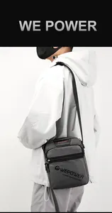 Detail of dark grey crossbody bag showing water-resistant nylon texture and dual zippers