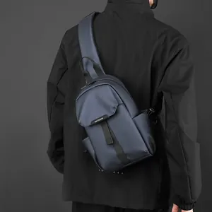 Waterproof navy blue nylon sling bag for men shown on model with WEPOWER logo