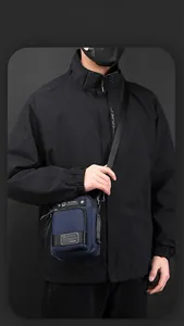 Close-up of waterproof dark blue crossbody bag with multiple zip pockets for men