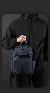 Detail shot of navy waterproof chest bag with vertical zipper and top handle texture