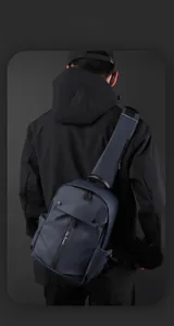 Detail of dark blue waterproof sling bag with adjustable wide shoulder strap and zipper pocket