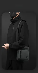 Detail of dark grey waterproof messenger bag with zipper pocket and adjustable strap
