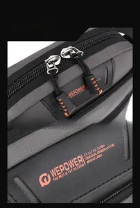 Detail of high-density gray fabric texture with orange accented zippers on outdoor bag