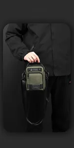 Detailed view of olive green waterproof crossbody bag with adjustable strap and zip pocket