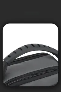 Detail view of water-resistant fabric and ergonomic non-slip handle on grey shoulder bag