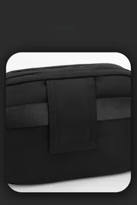 Detail view of durable black nylon crossbody bag with smart storage and dual zippers