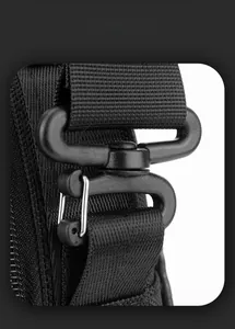 Detail of durable matte plastic buckle and high-density nylon strap on black shoulder bag