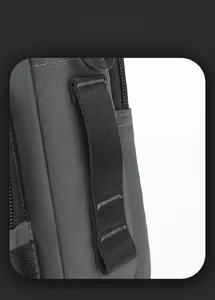 Detail showing high-density nylon fabric and reinforced stitching on a grey shoulder bag