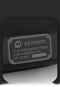 Detail of the high-quality grey rubber logo patch on a black nylon crossbody bag