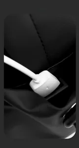 Macro view of the integrated USB charging port and cable on water-resistant black chest bag