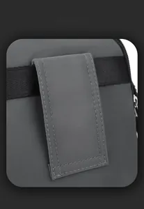 Detail of gray waterproof shoulder bag showing reinforced stitching and textured fabric