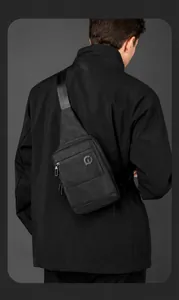 Detail of waterproof black men chest bag with double zippers and textured nylon fabric