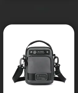 Close-up of gray waterproof nylon shoulder bag featuring multiple zipper compartments