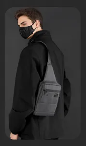 Detail view of water-resistant nylon chest bag with adjustable strap and smart storage