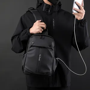 Waterproof minimalist black chest bag for men with USB charging port for mobile devices