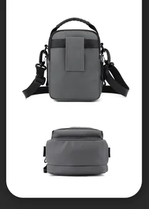 Detail view of the gray waterproof crossbody bag back straps and thick handle texture