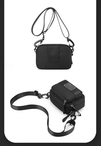 Detailed view of black nylon crossbody bag with zipper compartments and adjustable straps