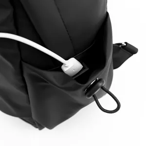 Waterproof black crossbody bag featuring an external USB charging port and side pocket