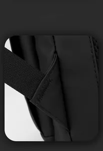 Detail of reinforced triangular stitching on black waterproof business laptop backpack