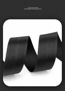 Detailed macro view of durable black nylon webbing with herringbone texture for chest bag
