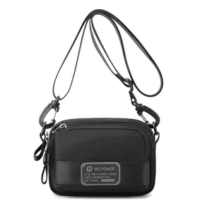 Men's minimalist black crossbody bag with durable nylon fabric and multi-layer zippers