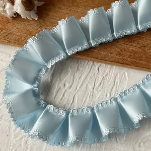 Close-up of light blue ruffled satin ribbon with delicate wavy edges for DIY crafts