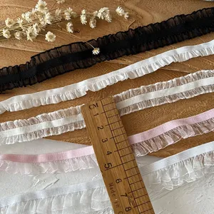 Elastic ruffled lace trim in black, white, and pink for DIY garment sewing projects