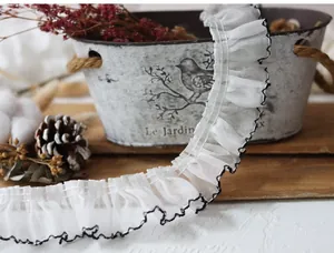 Close-up of 4cm pleated white lace trim with black contrast edges for sewing DIY crafts