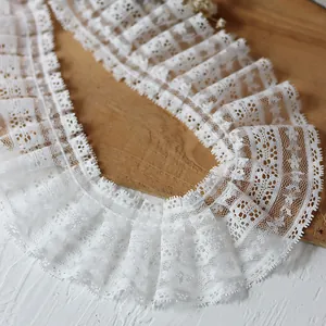 White pleated eyelash lace trim with intricate mesh design for clothing and DIY crafts