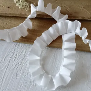Macro detail of 2.5cm white pleated satin ribbon with elegant ruffled texture for DIY sewing