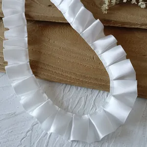 Detail of 2.5cm pleated white satin ribbon trim for doll clothes and DIY sewing projects