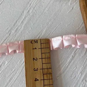 Pink ruffled satin ribbon lace trim for garment DIY sewing crafts with wooden ruler scale