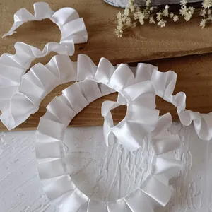 Detailed texture of white pleated satin ribbon for garment DIY and dressmaking
