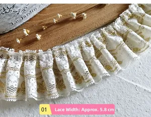 Detail of 5.8cm white pleated lace with gold floral embroidery on vintage wooden background