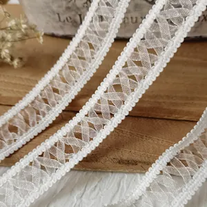 White elastic lace ribbon with diamond mesh pattern and scalloped edges for DIY crafts