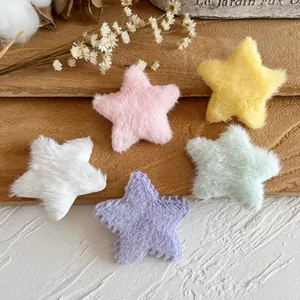 Colorful plush five-pointed stars for DIY crafts and hair accessories on wood