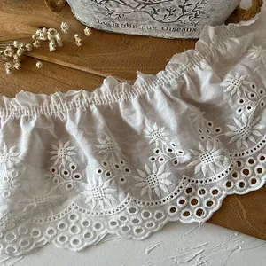 White eyelet lace trim with sunflower embroidery and ruffled edges for DIY sewing