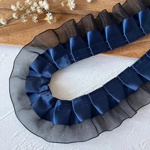 Close-up of pleated navy blue lace trim with double-layered organza for DIY sewing