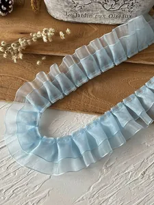 Close-up of ruffled light blue organza lace trim for DIY sewing and dress decoration